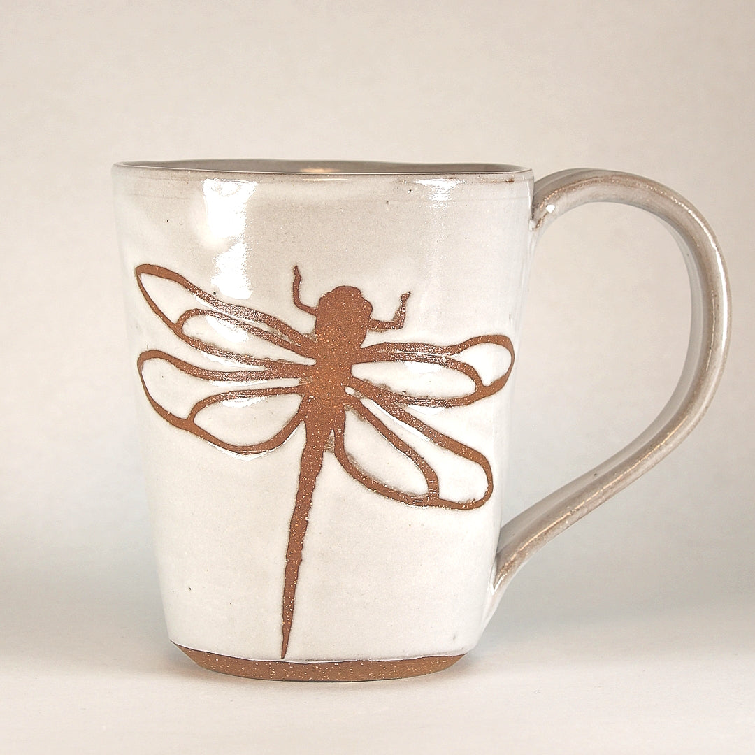 White ceramic mug with dragonfly stencil