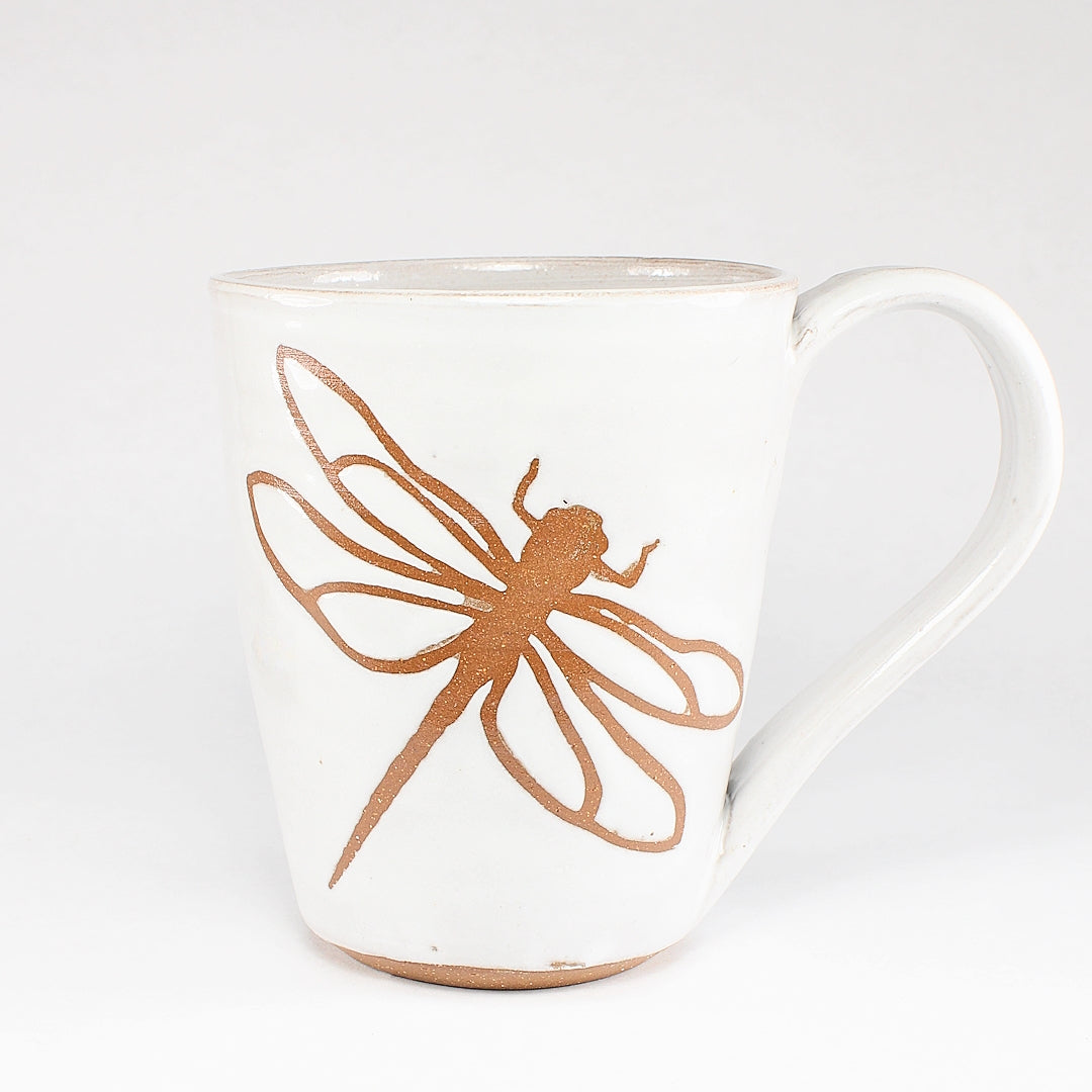 White ceramic mug with dragonfly stencil