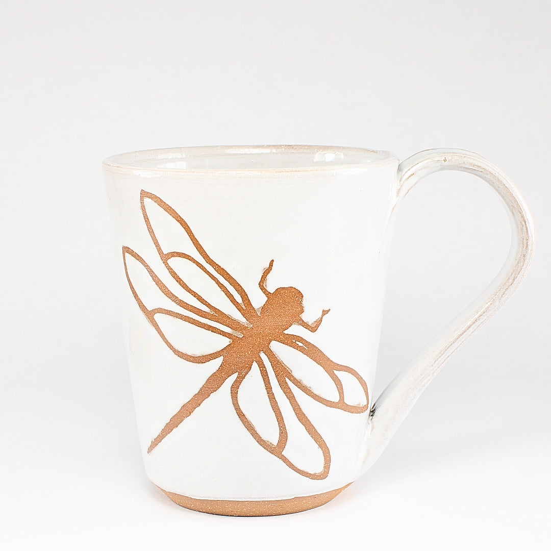 White ceramic mug with dragonfly stencil