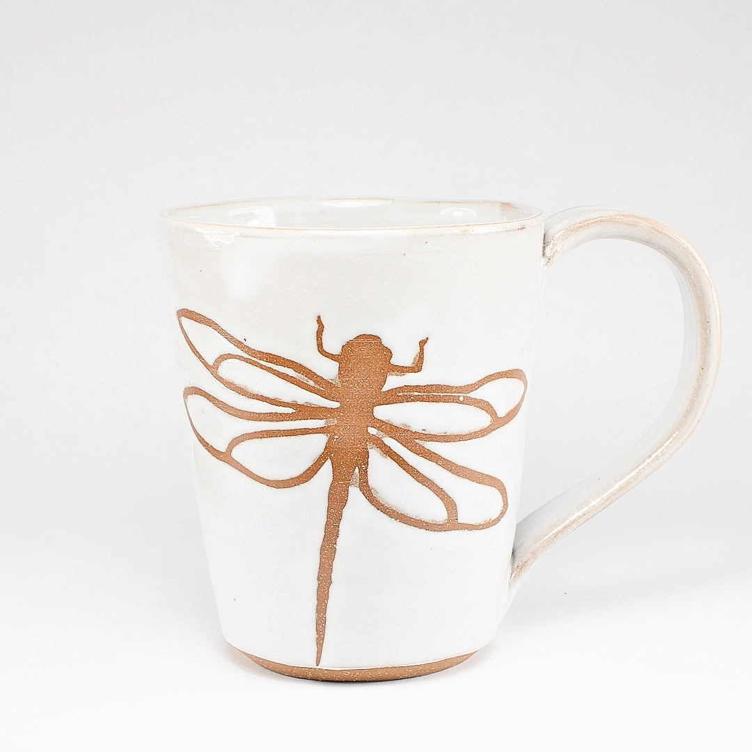 White ceramic mug with dragonfly stencil