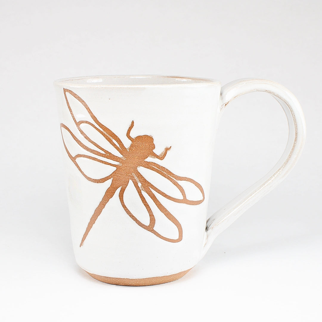 White ceramic mug with dragonfly stencil