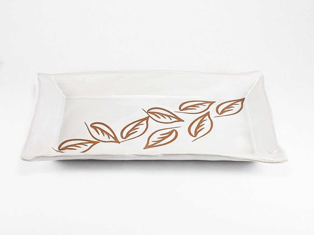 White ceramic tray with leaf stencils - angle view